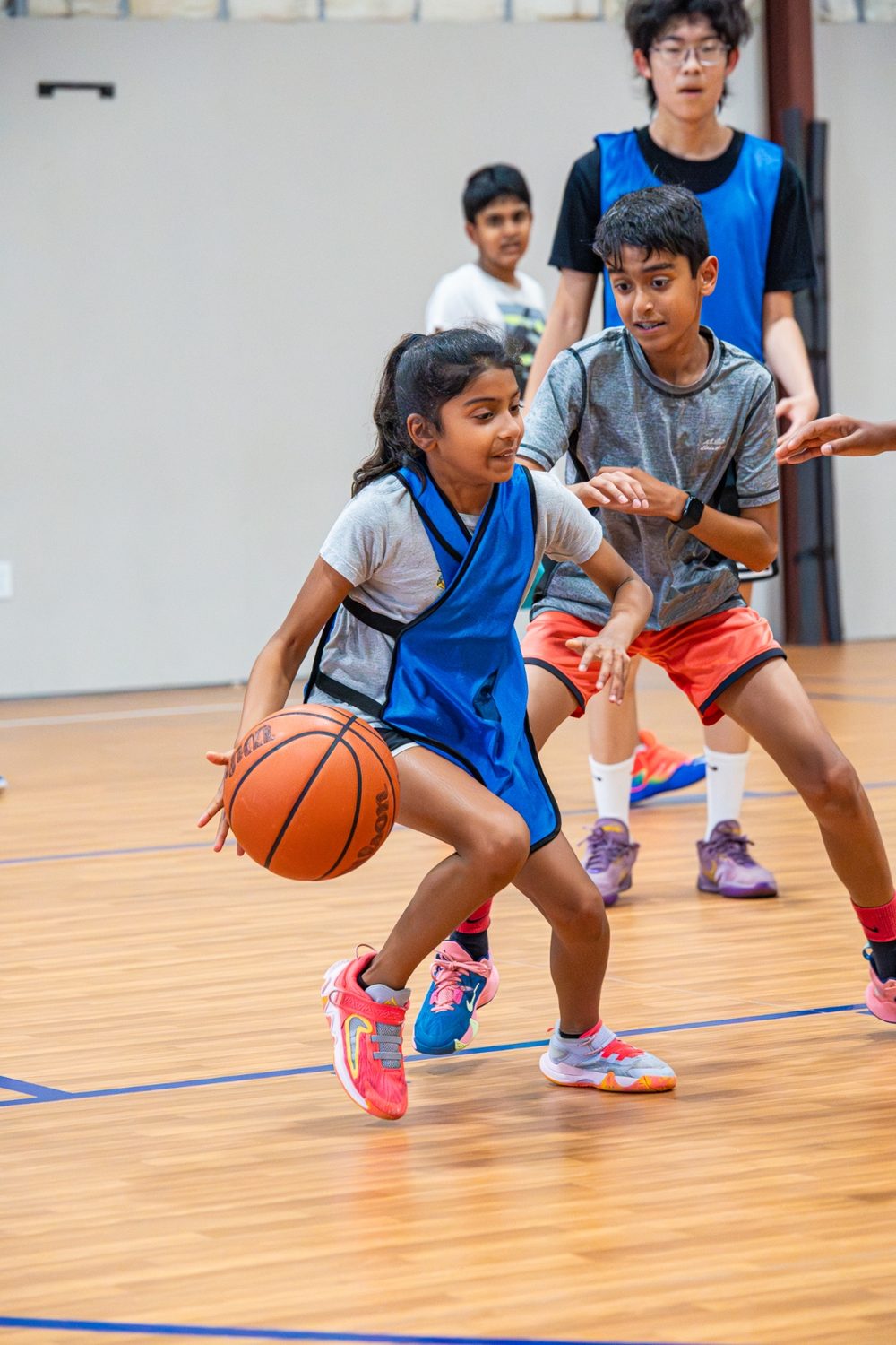 A young athlete dribbling around a defender during a small-sided game