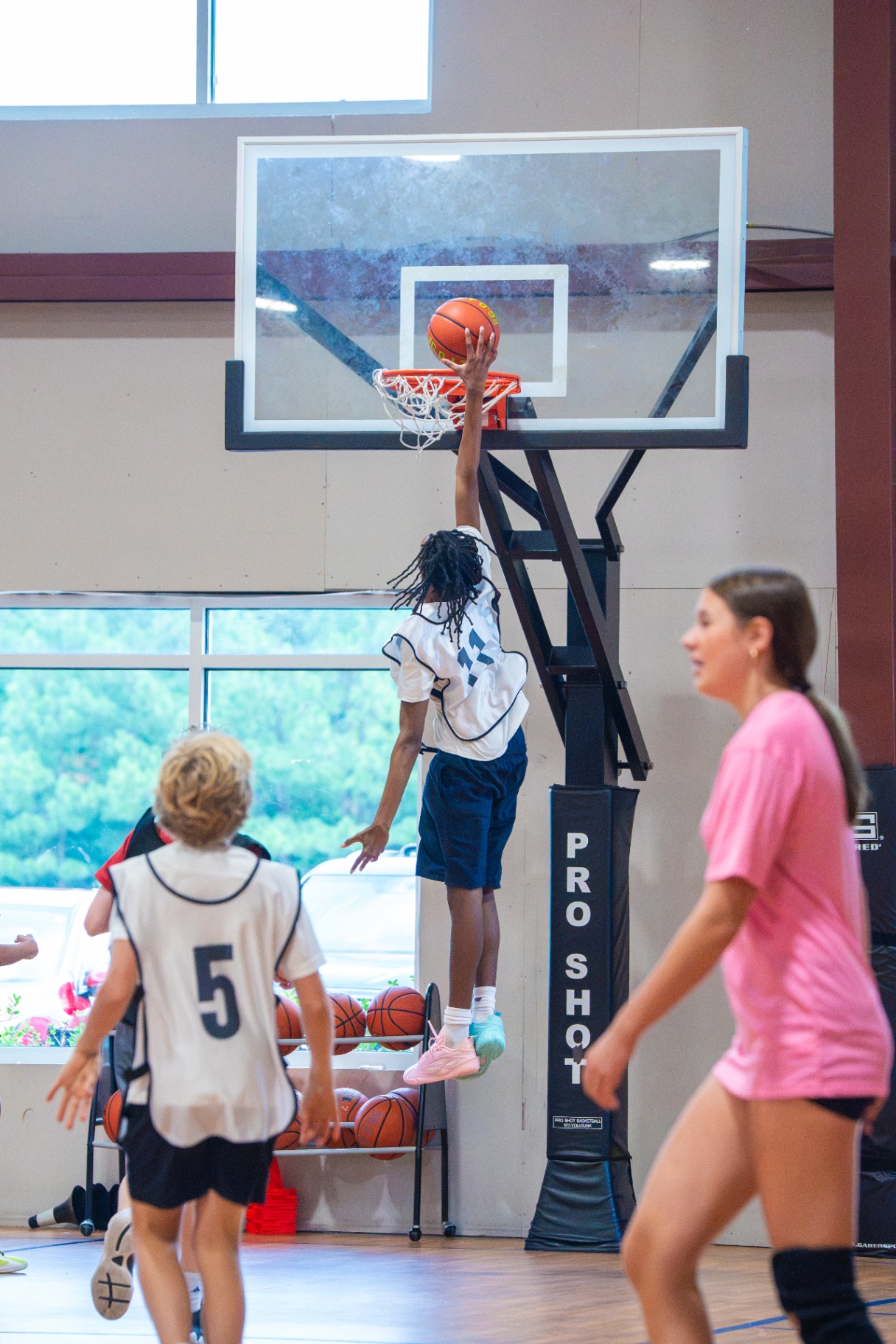 Player elevating for a high finish at the rim on the Pro Shot hoop