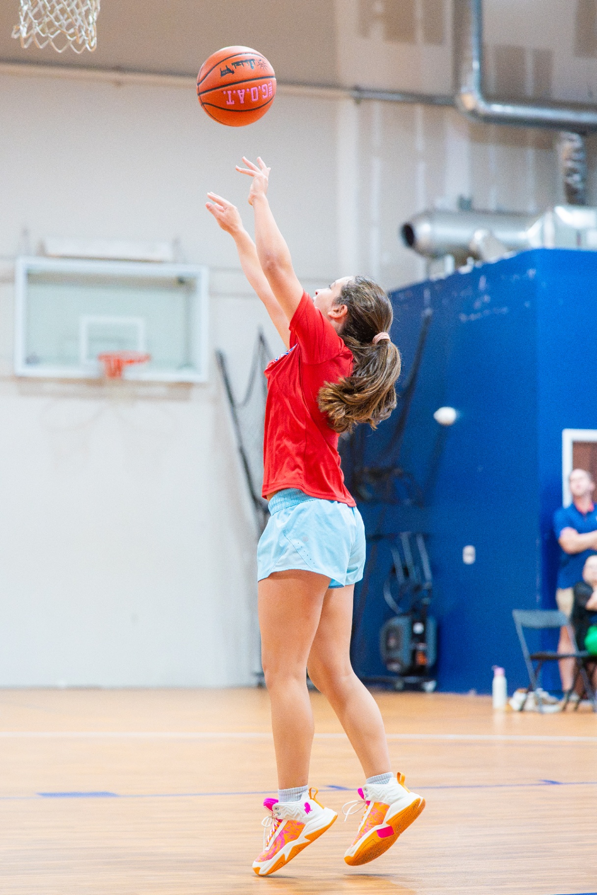Athlete releasing a jumper with high arc on the shot