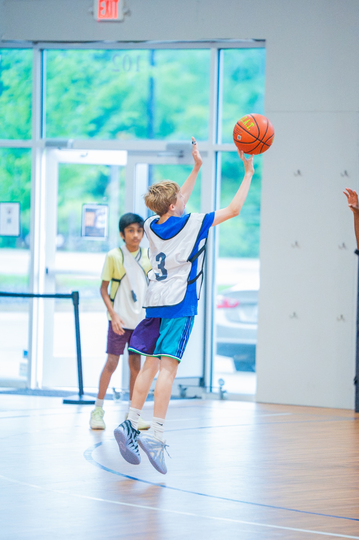 Young athlete finishing a layup during a live small-sided game