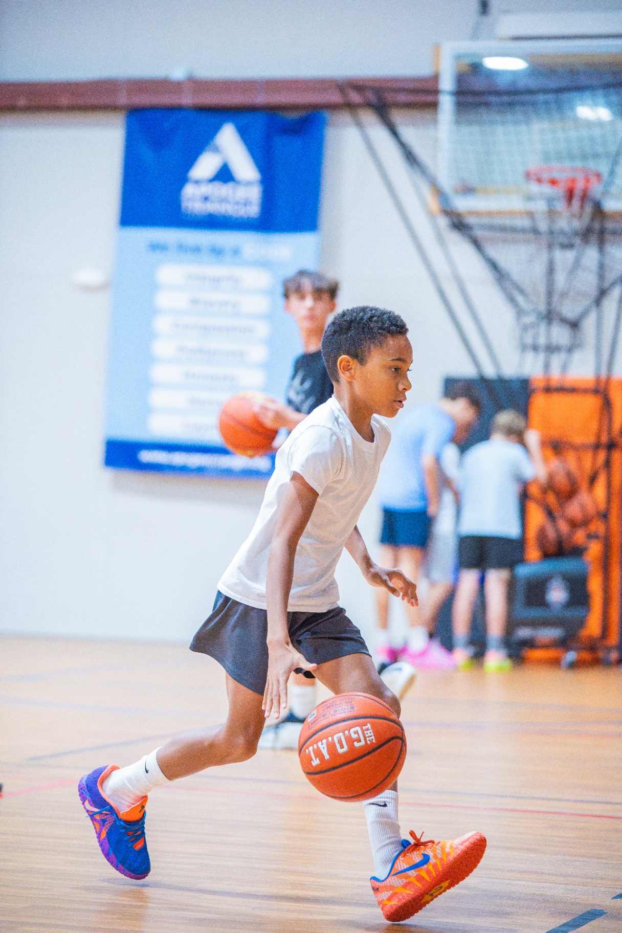 Athlete driving hard on a fast break during a Saturday session