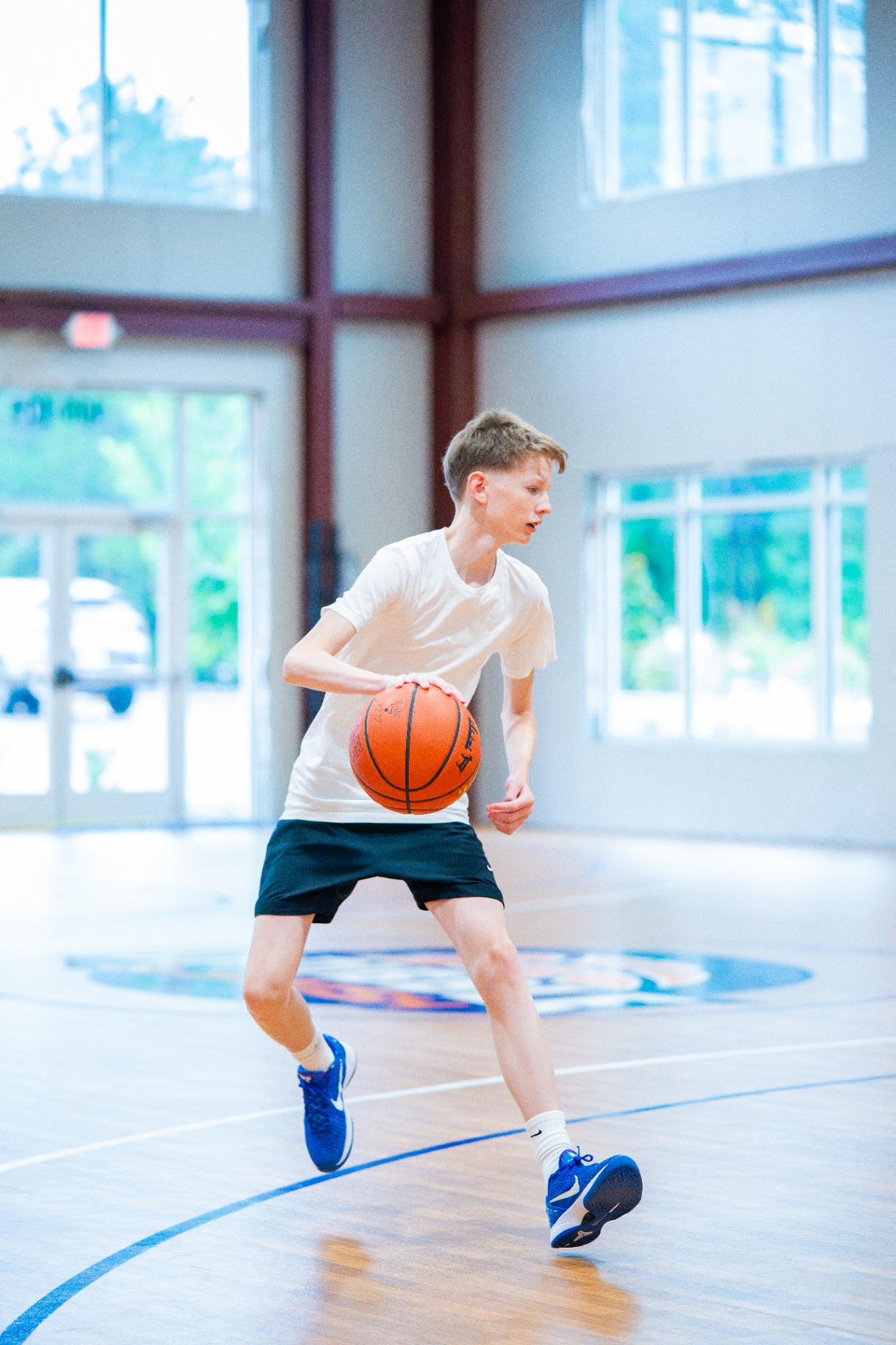 Player planting hard and changing direction with the ball at center court