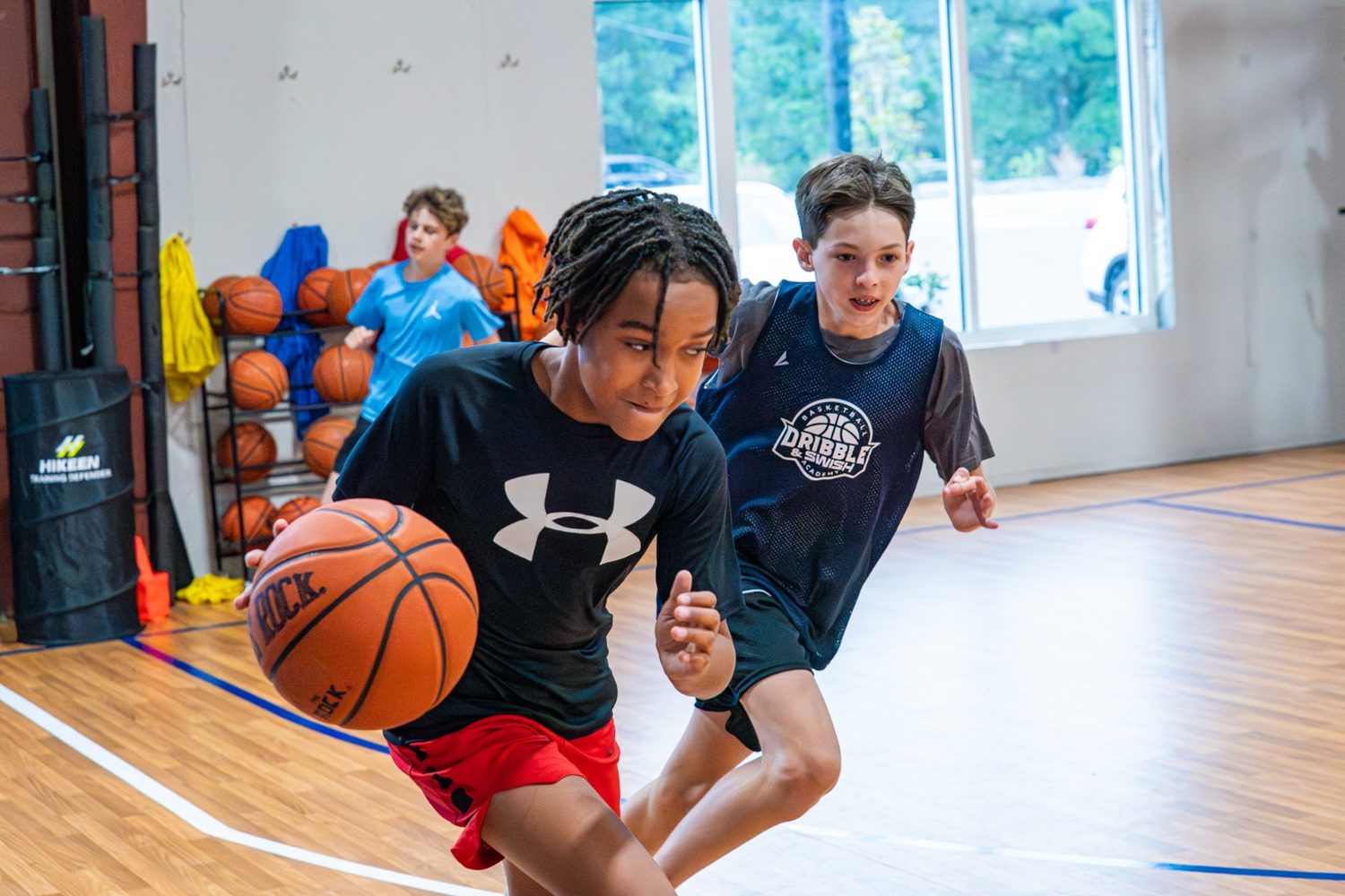 Two athletes racing down the court on a fast break