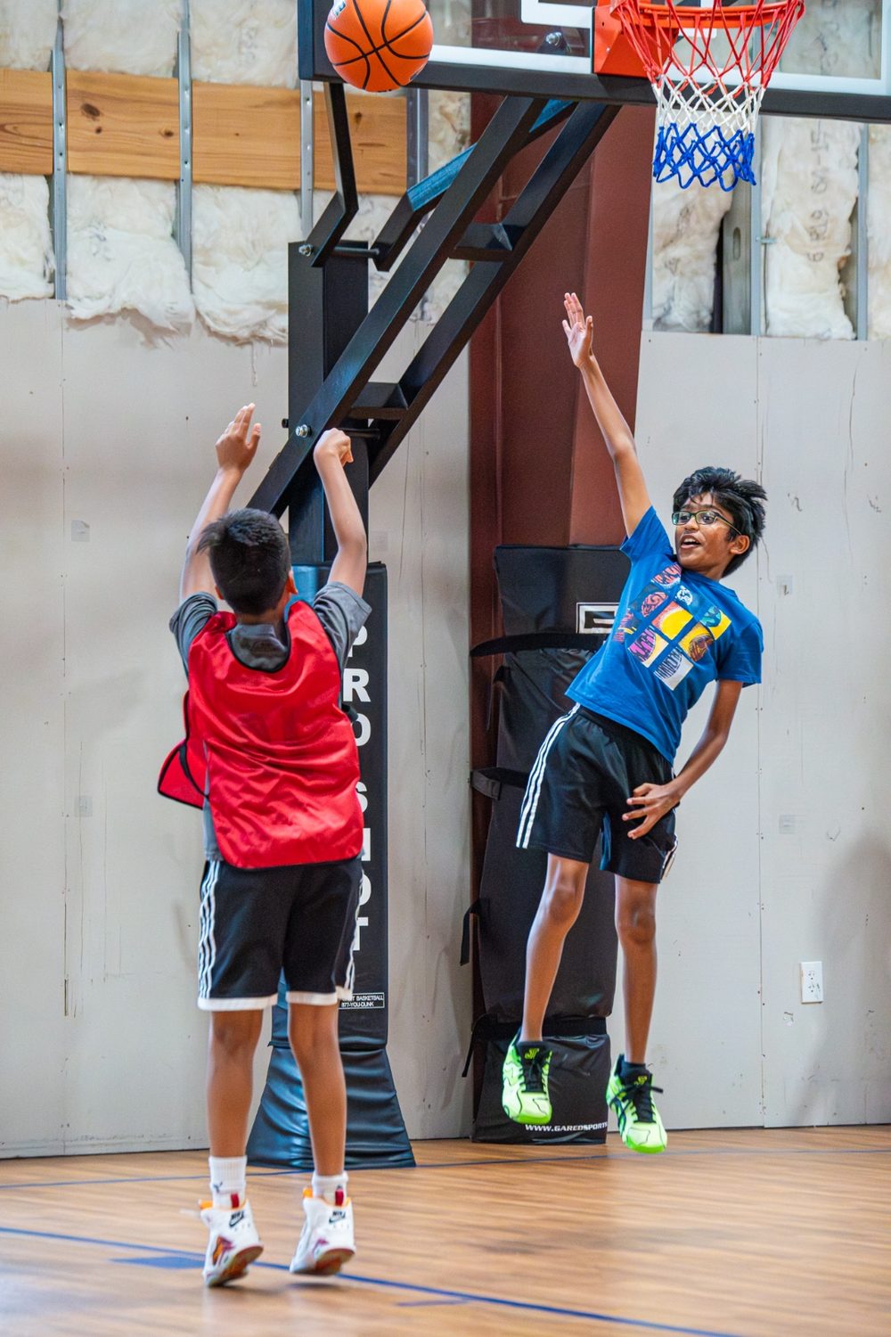 Two athletes contesting a shot at the rim