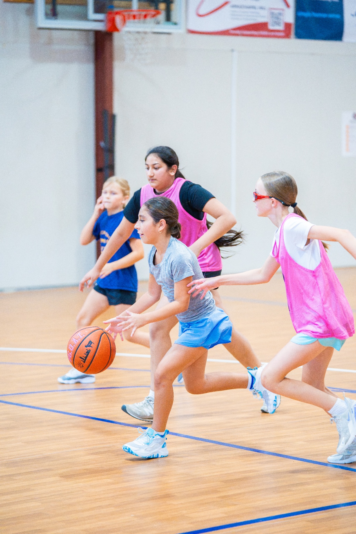Group of young athletes chasing a loose ball during a live scrimmage