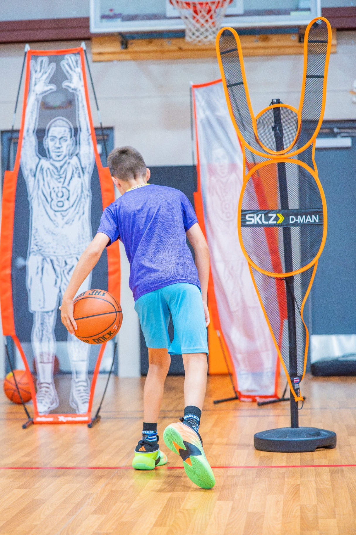 Player dribbling through defender mannequins during a skill-development station